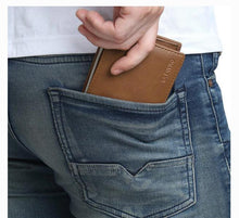 Load image into Gallery viewer, Pleather texture vegan wallet being placed in pocket